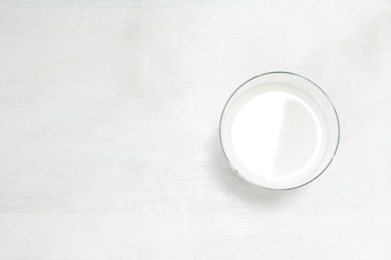 Plant-based milk in glass containers on a kitchen table