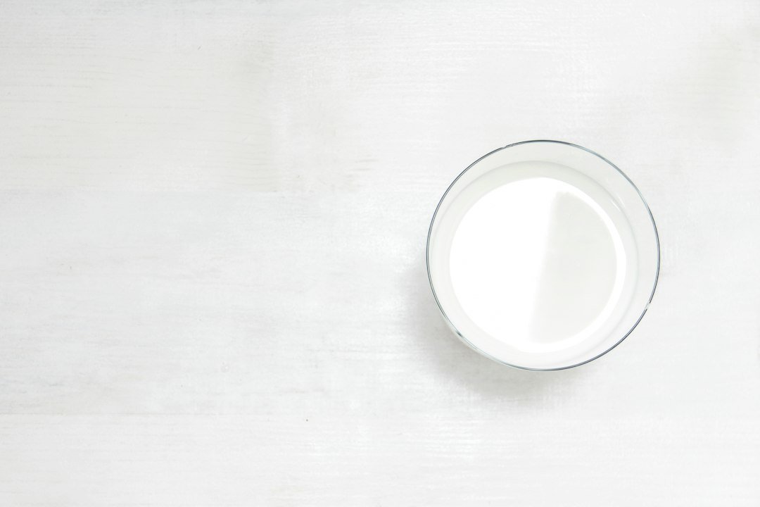 Plant-based milk in glass containers on a kitchen table