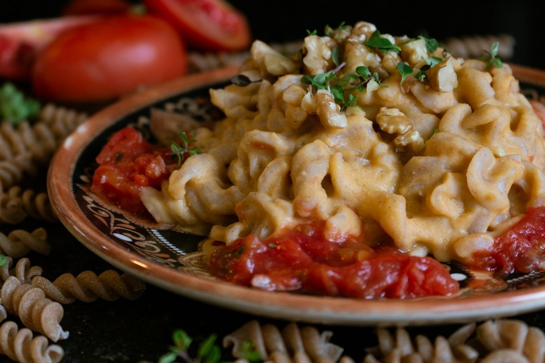Creamy vegan pasta in a bowl with herbs