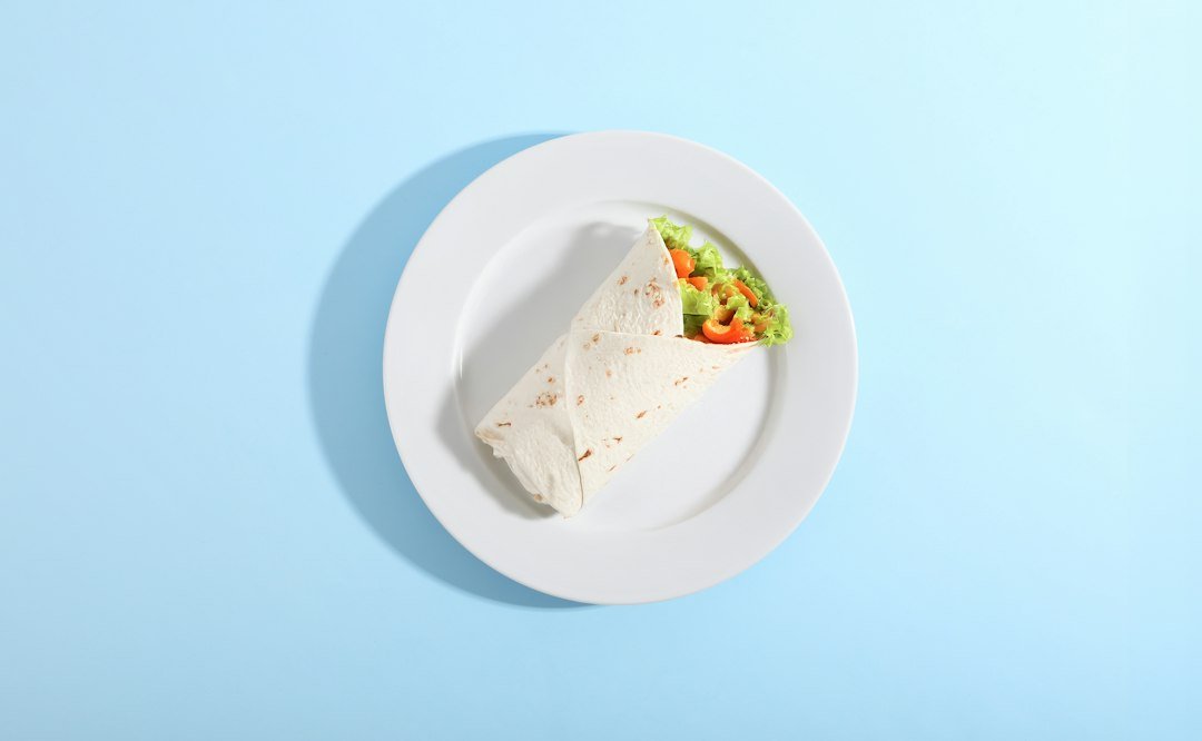 Cold vegan lunch meal prep with salad and wraps