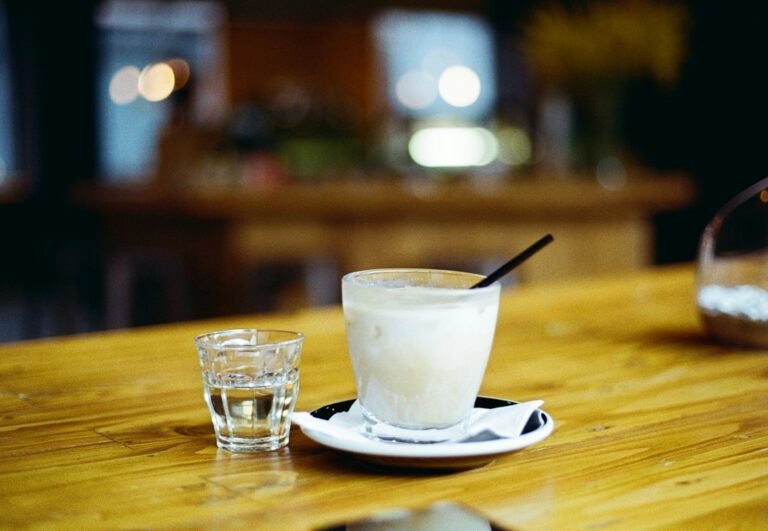 Oats and oat beverage illustrating why homemade oat milk thickens when heated