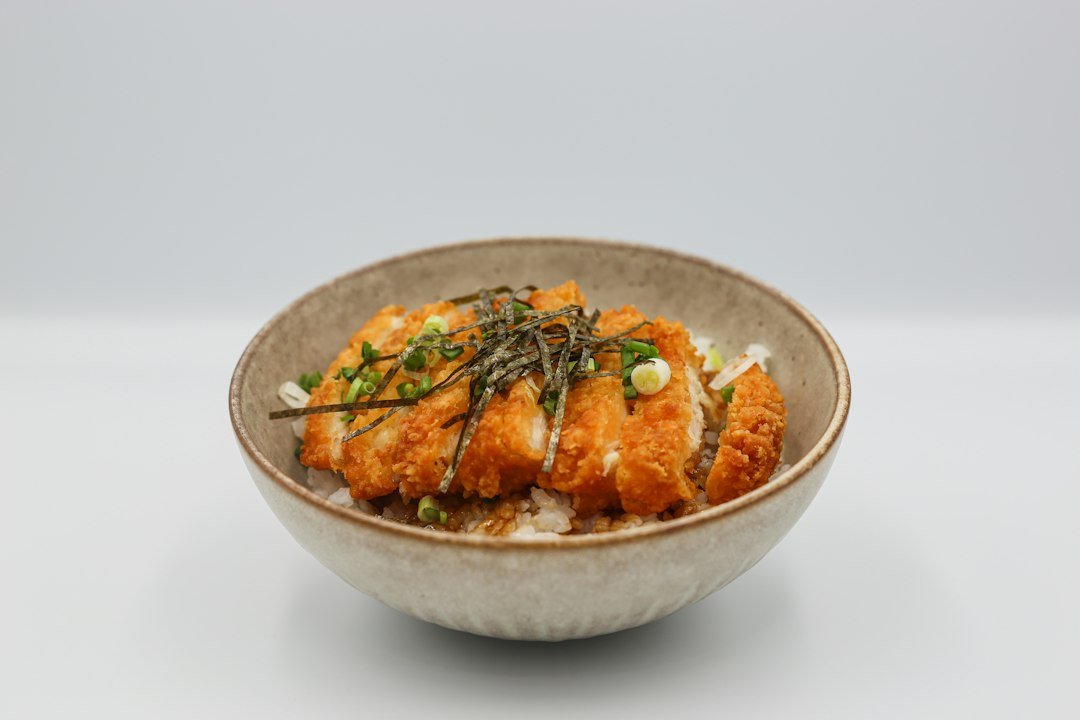 Seasoned tempeh with vegetables in a bowl, illustrative stock photo